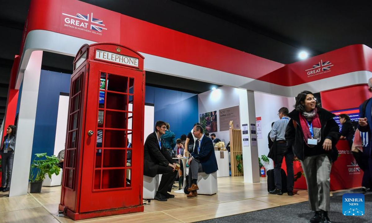 Attendees communicate at an exhibition area of the 29th session of the Conference of the Parties to the United Nations Framework Convention on Climate Change (UNFCCC) in Baku, Azerbaijan, Nov. 11, 2024.  (Photo: Xinhua)