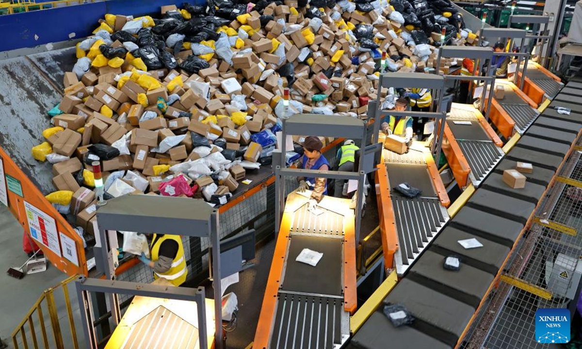 A drone photo shows staff members sorting packages at a logistic center of Daoxian branch of China Post in Daoxian County, central China's Hunan Province, Nov. 11, 2024. Manufacturers, e-commerce platforms and logistics companies across the country are busy coping with customer's demand during China's annual Double 11 shopping festival.  (Photo: Xinhua)