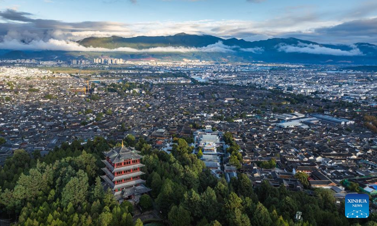 An aerial drone photo taken on Nov. 8, 2024 shows the scenery of Lijiang ancient town during sunset in southwest China's Yunnan Province. With the goal to build a world famous tourism city, Lijiang has been improving the service in its scenic spots such as Lijiang ancient town and Yulong Snow Mountain, in an effort to promote the high-quality development of its cultural tourism market.  (Photo: Xinhua)