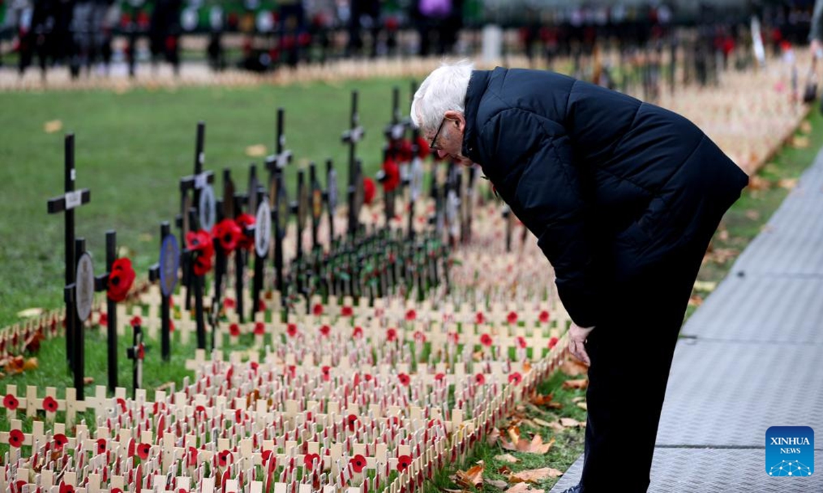 A man looks at poppy petals and crosses at the Field of Remembrance at Westminster Abbey on the occasion of Remembrance Day in London, Britain, on Nov. 11, 2024. Remembrance Day is observed to remember the sacrifices made by soldiers during the WWI, which ended on Nov. 11, 1918. (Photo: Xinhua)