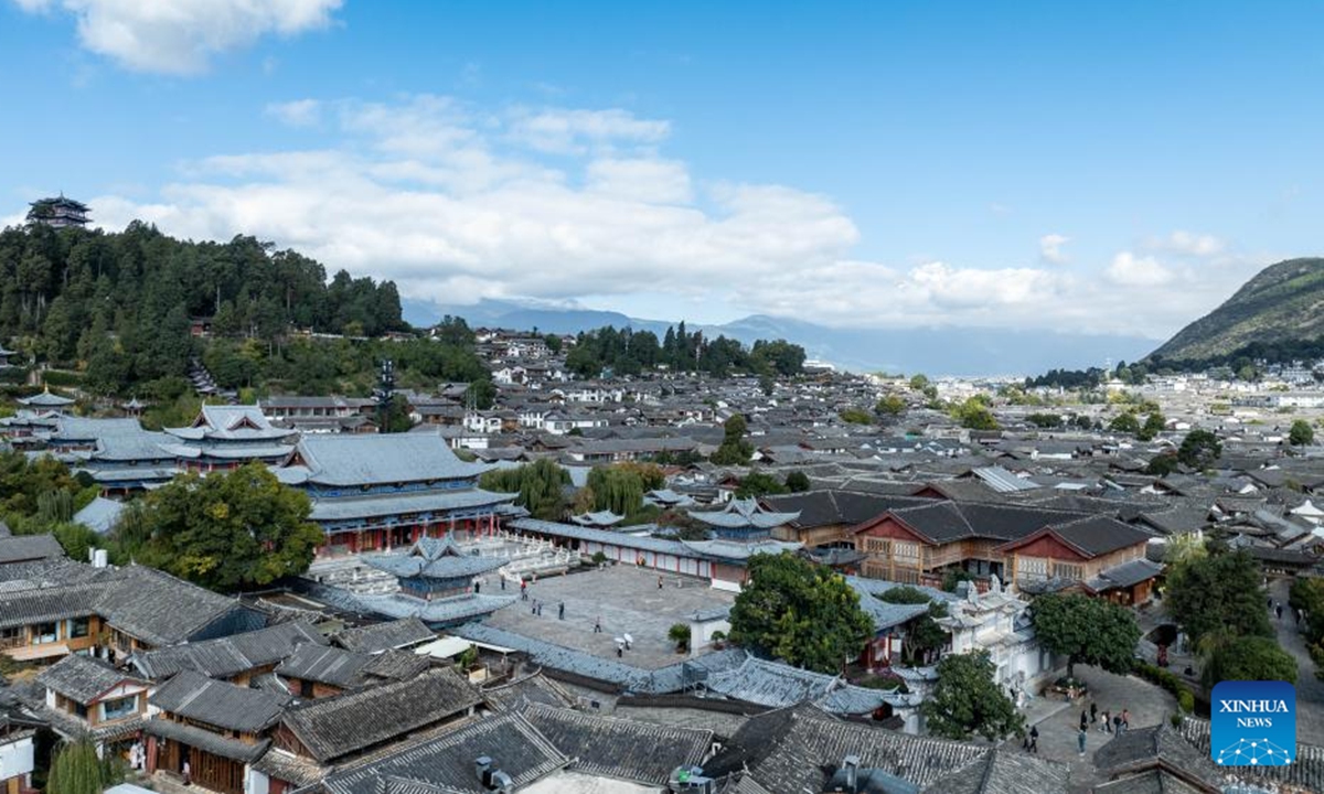 An aerial drone photo taken on Nov. 10, 2024 shows people visiting Lijiang ancient town in southwest China's Yunnan Province. With the goal to build a world famous tourism city, Lijiang has been improving the service in its scenic spots such as Lijiang ancient town and Yulong Snow Mountain, in an effort to promote the high-quality development of its cultural tourism market.  (Photo: Xinhua)