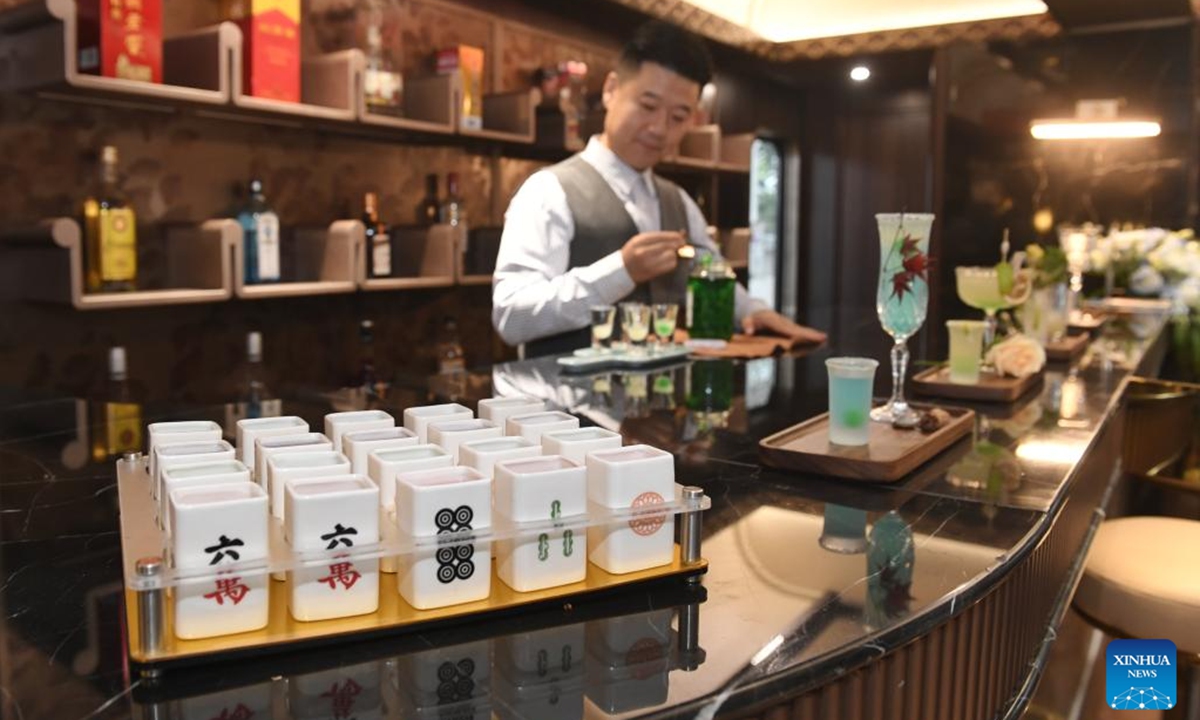 A bartender makes cocktail aboard a panda-themed tourist train at Anjing Railway Station in Chengdu, southwest China's Sichuan Province, Nov. 10, 2024.   (Photo: Xinhua)