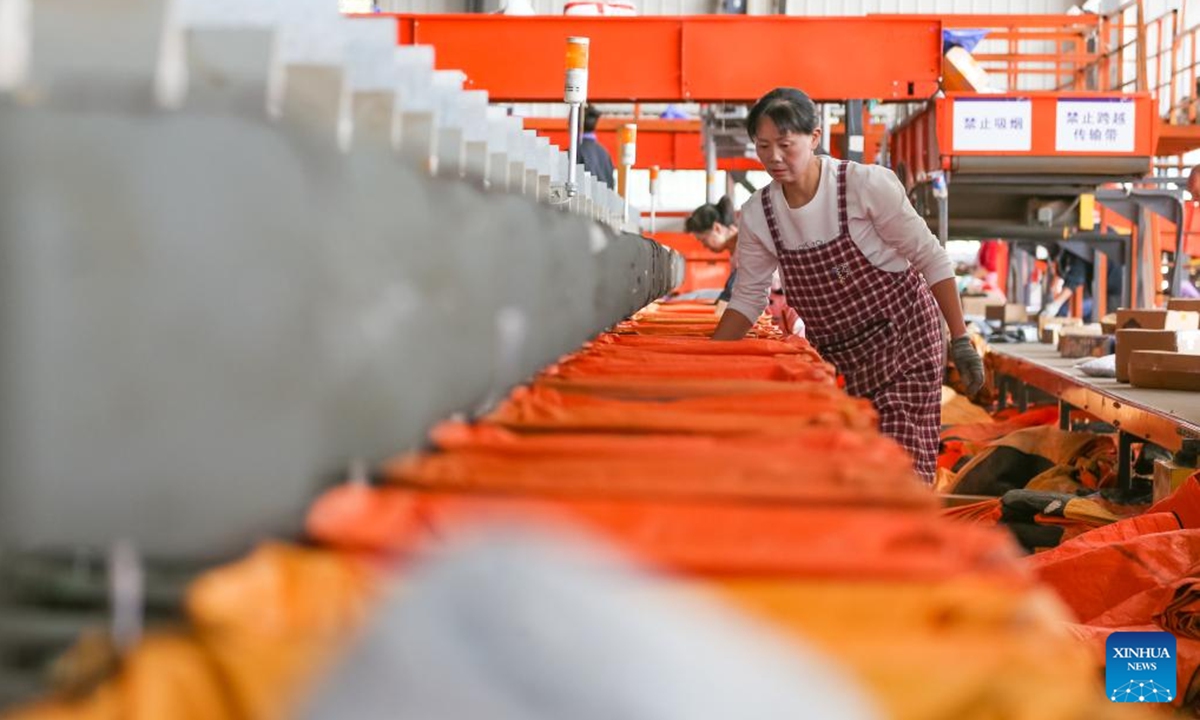 Staff members sort packages at a logistic center of YTO Express in Jurong City, east China's Jiangsu Province, Nov. 11, 2024. Manufacturers, e-commerce platforms and logistics companies across the country are busy coping with customer's demand during China's annual Double 11 shopping festival.   (Photo: Xinhua)