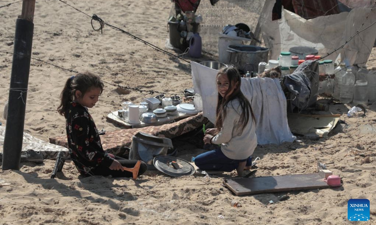 Displaced children are seen by a tent in the northwest of Khan Younis, southern Gaza Strip, on Nov. 12, 2024.  (Photo: Xinhua)