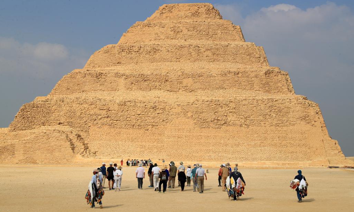 Tourists visit the Step Pyramid complex in the Saqqara necropolis, south of Cairo, Egypt, on Nov. 12, 2024. The Step Pyramid, a UNESCO World Heritage Site, was designed and built by the architect Imhotep in the 27th century BC during the Third Dynasty to hold the mummy of Pharaoh Djoser. (Photo: Xinhua)