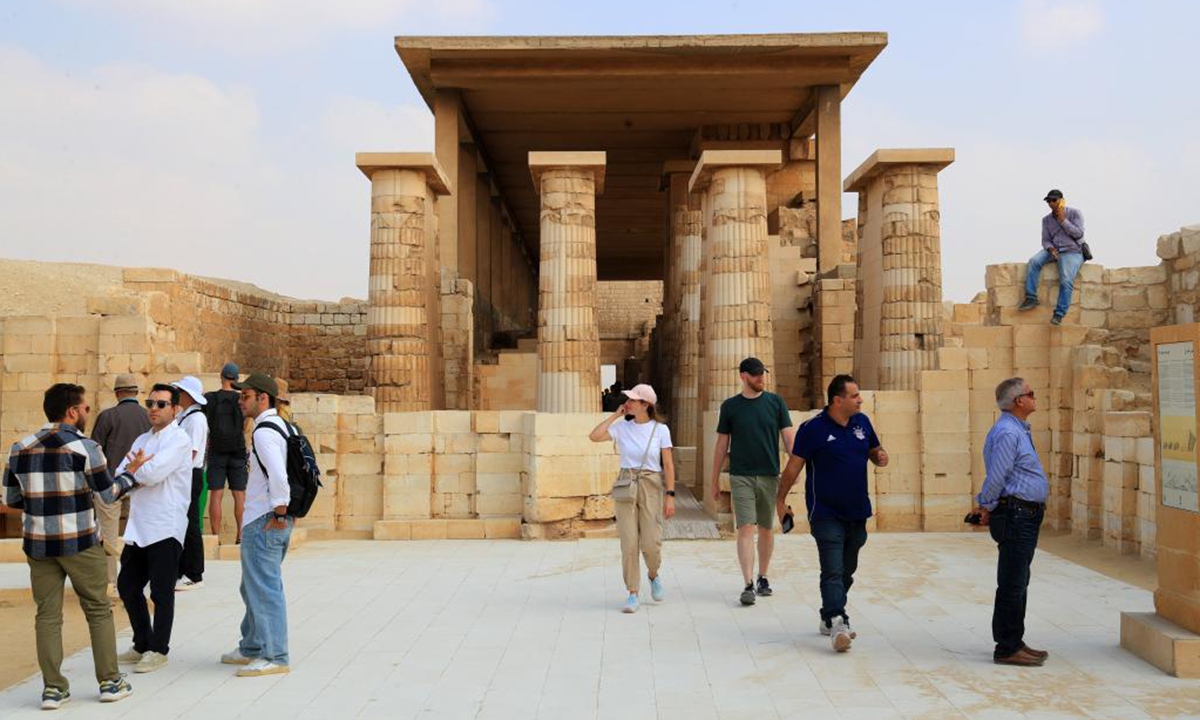 Tourists visit the Step Pyramid complex in the Saqqara necropolis, south of Cairo, Egypt, on Nov. 12, 2024. The Step Pyramid, a UNESCO World Heritage Site, was designed and built by the architect Imhotep in the 27th century BC during the Third Dynasty to hold the mummy of Pharaoh Djoser. (Photo: Xinhua)