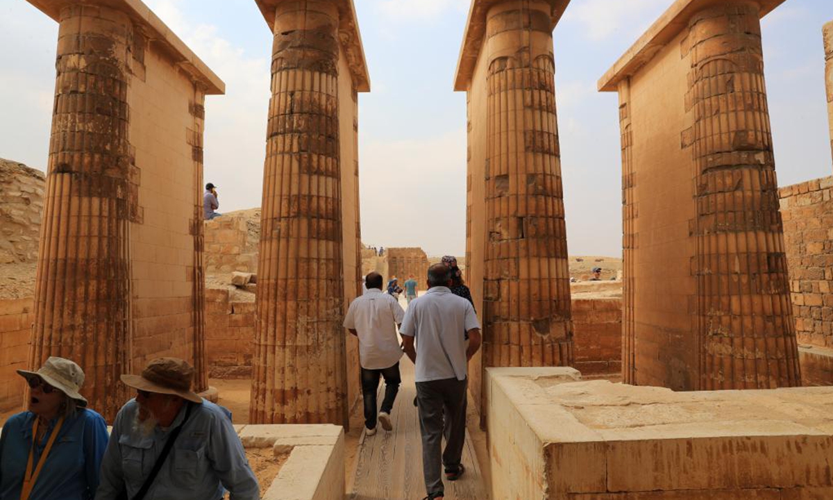 Tourists visit the Step Pyramid complex in the Saqqara necropolis, south of Cairo, Egypt, on Nov. 12, 2024. The Step Pyramid, a UNESCO World Heritage Site, was designed and built by the architect Imhotep in the 27th century BC during the Third Dynasty to hold the mummy of Pharaoh Djoser. (Photo: Xinhua)