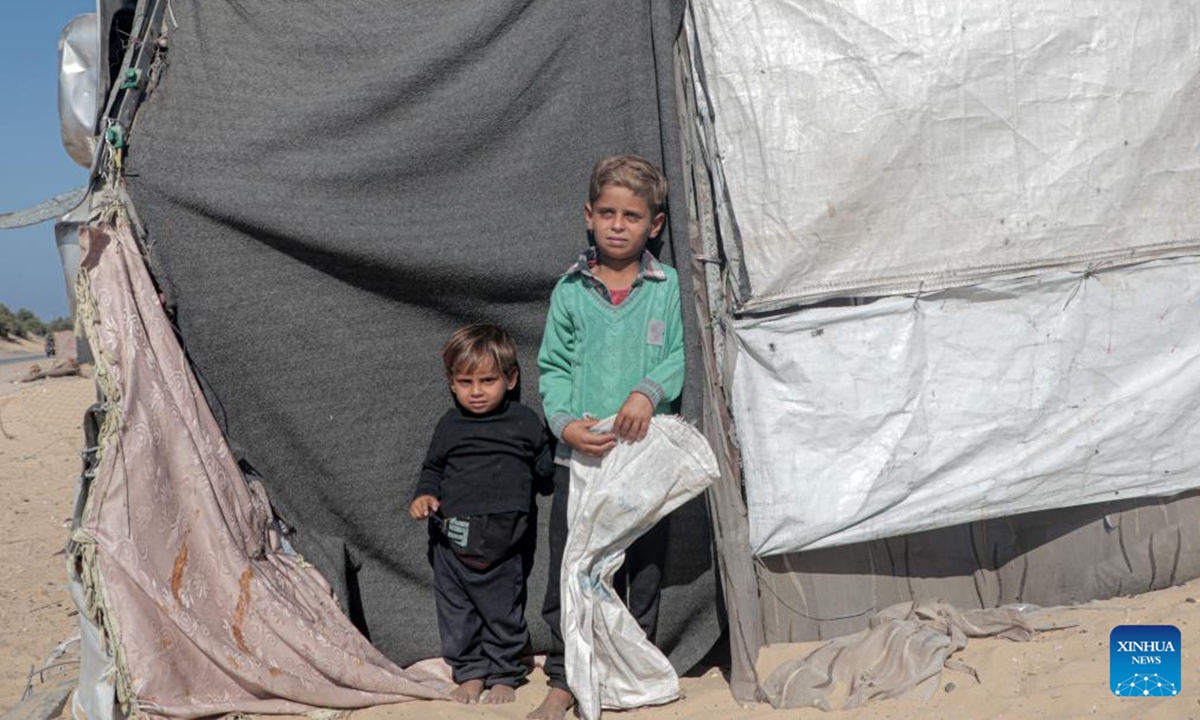 Displaced children stand by a tent in the northwest of Khan Younis, southern Gaza Strip, on Nov. 12, 2024.  (Photo: Xinhua)