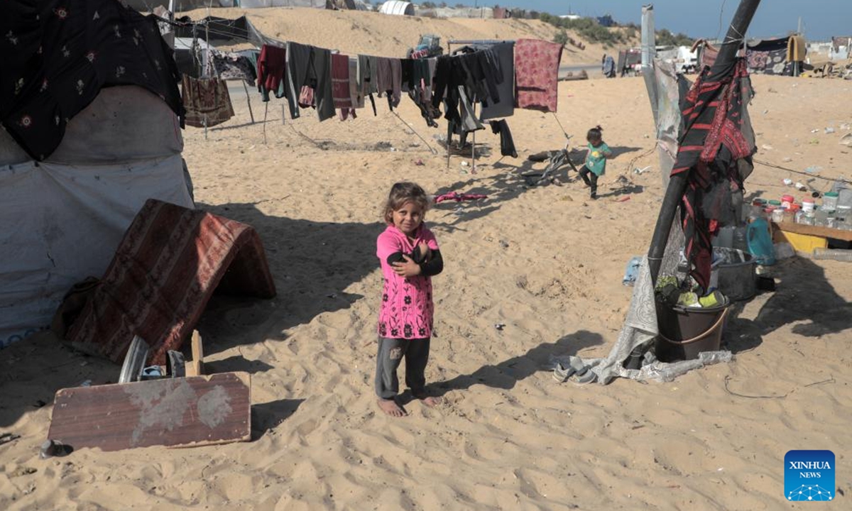 A girl stands beside a tent for displaced Palestinians in the northwest of Khan Younis, southern Gaza Strip, on Nov. 12, 2024.  (Photo: Xinhua)