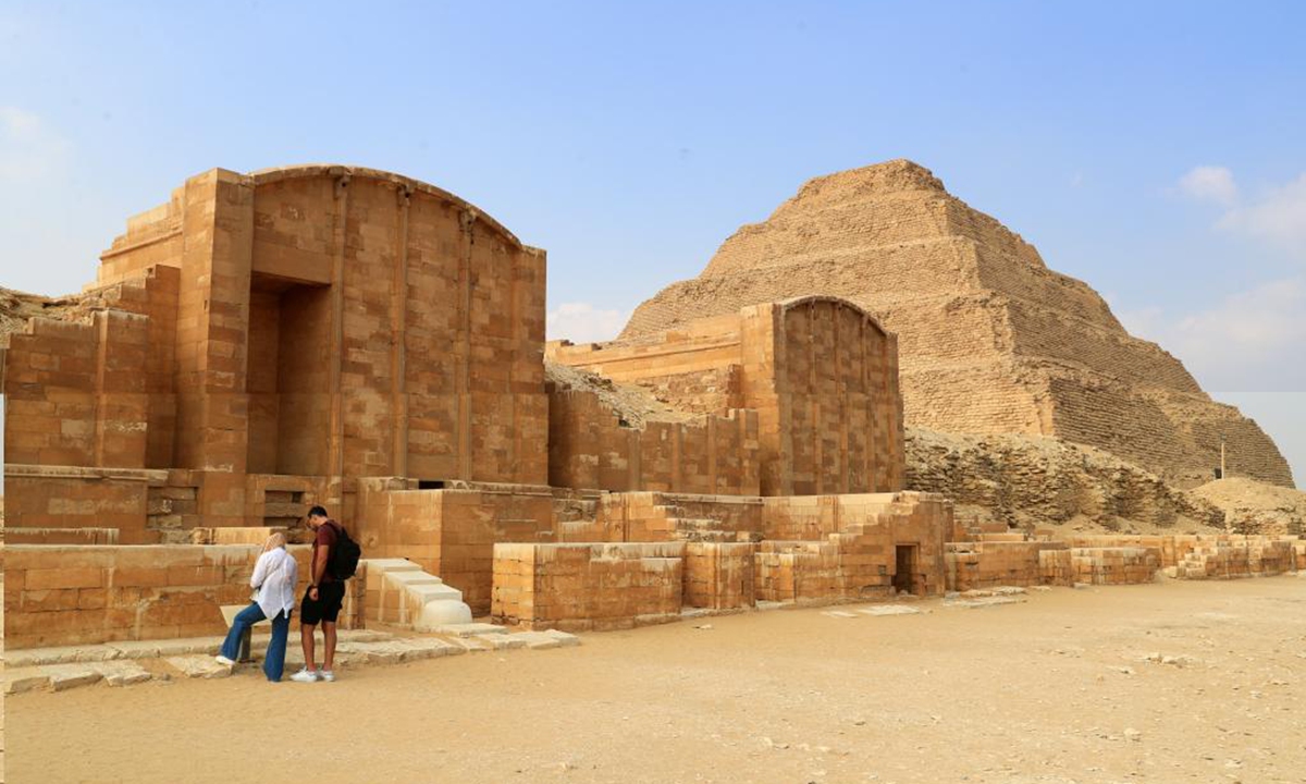 Tourists visit the Step Pyramid complex in the Saqqara necropolis, south of Cairo, Egypt, on Nov. 12, 2024. The Step Pyramid, a UNESCO World Heritage Site, was designed and built by the architect Imhotep in the 27th century BC during the Third Dynasty to hold the mummy of Pharaoh Djoser. (Photo: Xinhua)