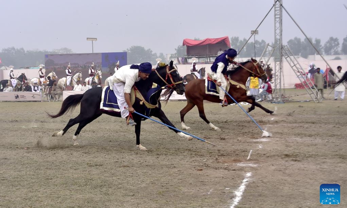 Horsemen compete during a tent pegging competition in northwest Pakistan's Peshawar on Nov. 11, 2024. In tent pegging, a horseman gallops and uses a sword or a lance to pierce, pick up and carry away a wooden peg. (Photo: Xinhua)