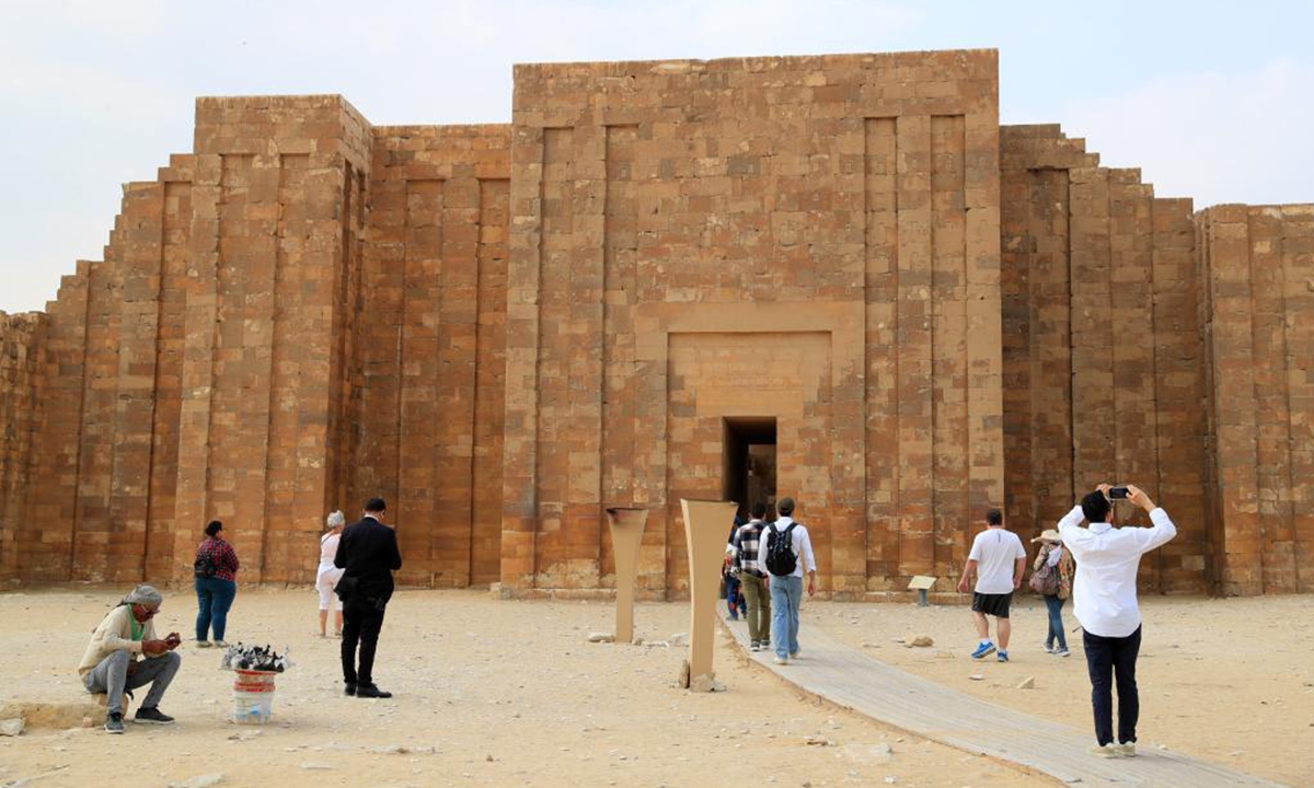 Tourists visit the Step Pyramid complex in the Saqqara necropolis, south of Cairo, Egypt, on Nov. 12, 2024. The Step Pyramid, a UNESCO World Heritage Site, was designed and built by the architect Imhotep in the 27th century BC during the Third Dynasty to hold the mummy of Pharaoh Djoser. (Photo: Xinhua)