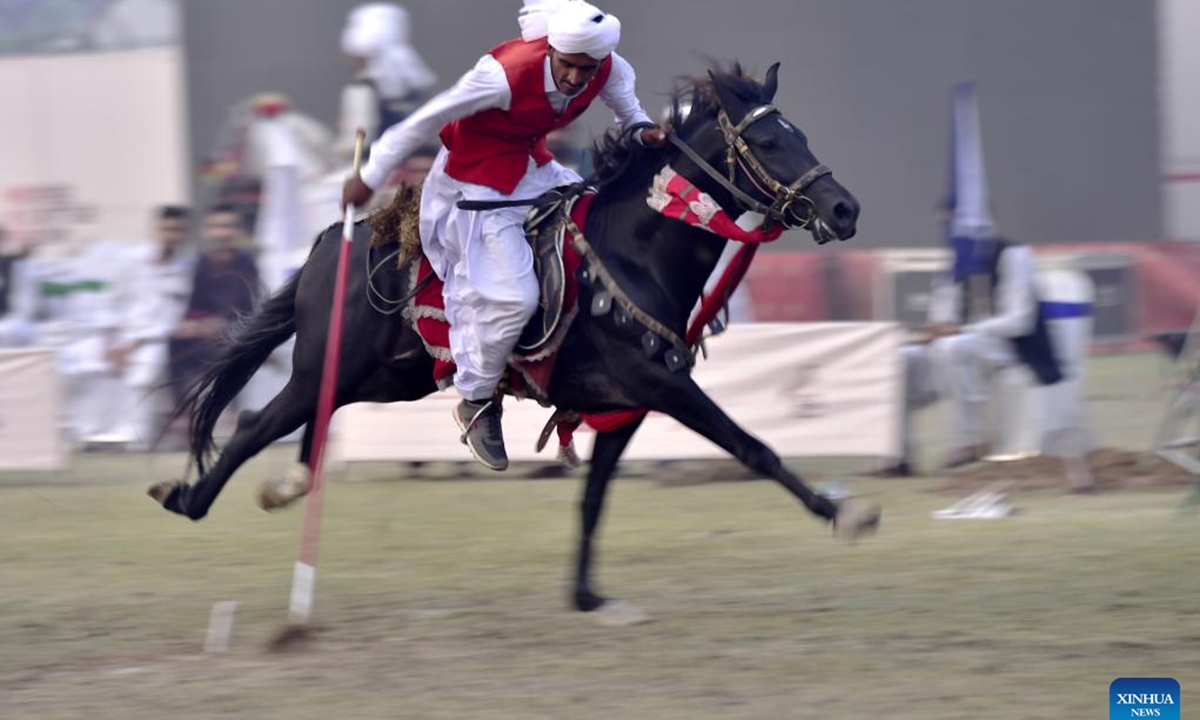 A horseman competes during a tent pegging competition in northwest Pakistan's Peshawar on Nov. 11, 2024. In tent pegging, a horseman gallops and uses a sword or a lance to pierce, pick up and carry away a wooden peg. (Photo: Xinhua)