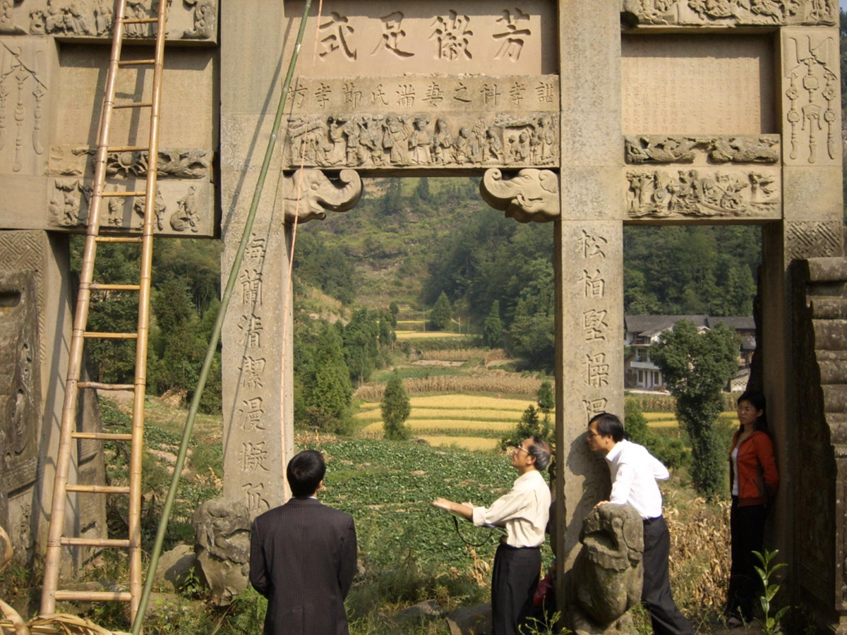 Sun Hui (left) and Sun Ru conduct on-site surveying and mapping at a traditional Chinese archway, in September 2007. Photo: Courtesy of Sun Ru