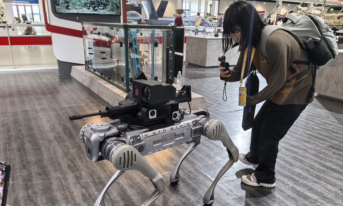 A Global Times reporter films a Grey Wolf multi-function quadruped anti-terrorism robot at Airshow China 2024 in Zhuhai, South China's Guangdong Province, on November 10, 2024. Photo: Yang Sheng/GT