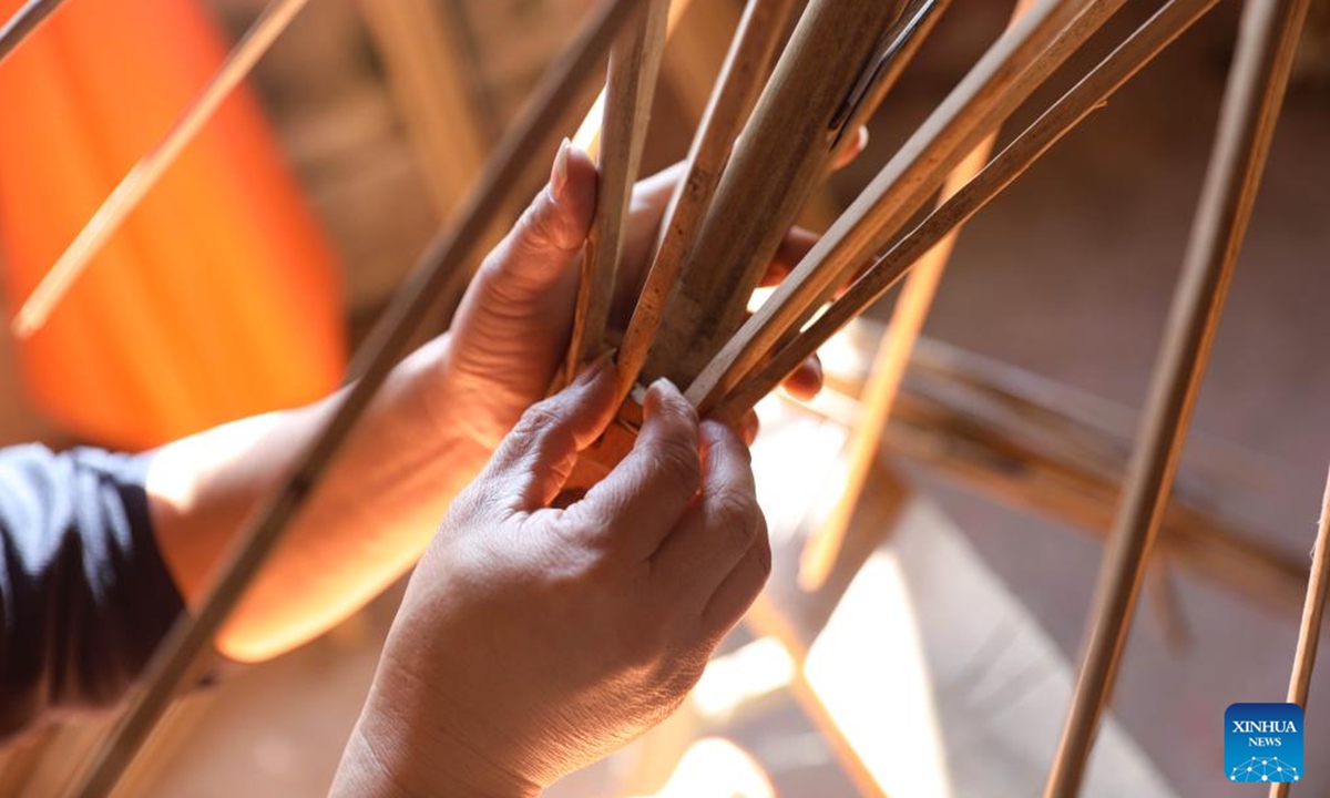 A worker makes ribs for an oilcloth umbrella in Gufeng Village of Jingxian County, east China's Anhui Province, Nov. 13, 2024. The umbrella, made of oiled cloth and bamboo frame, is a traditional Chinese handicraft.  (Photo: Xinhua)