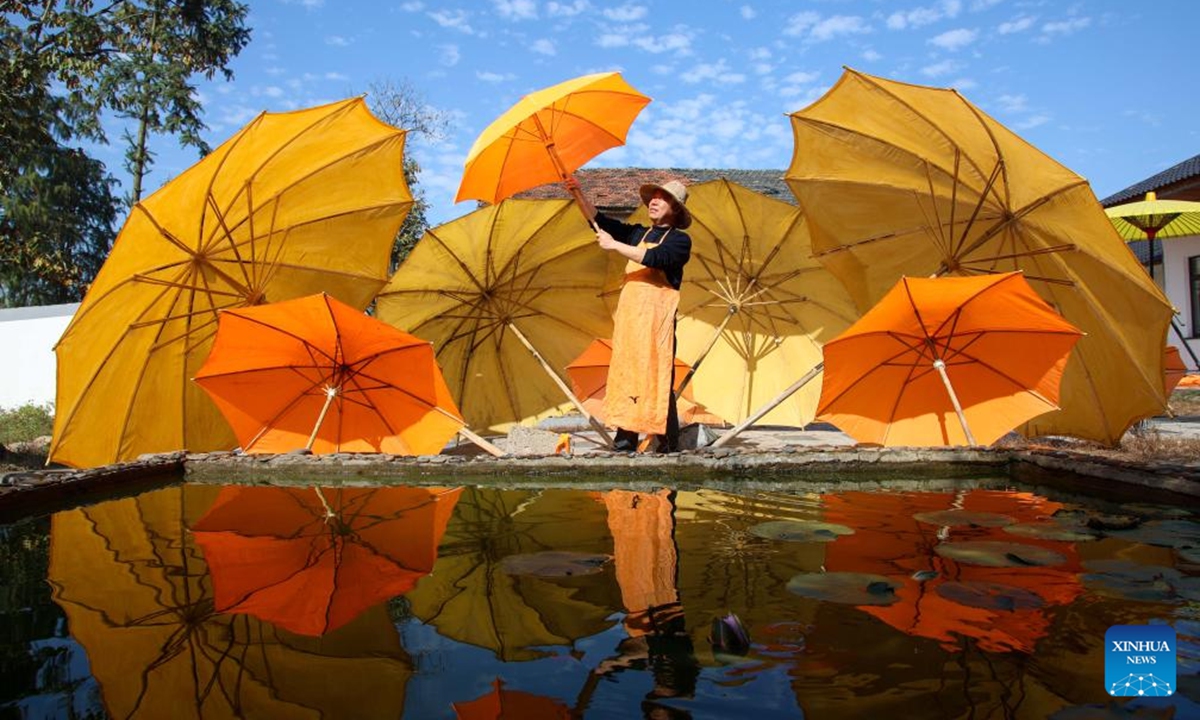 A worker airs oilcloth umbrellas in Gufeng Village of Jingxian County, east China's Anhui Province, Nov. 13, 2024. The umbrella, made of oiled cloth and bamboo frame, is a traditional Chinese handicraft.  (Photo: Xinhua)