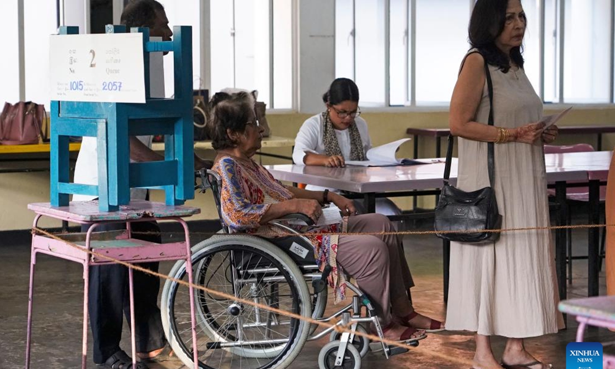 People vote at a polling station in Colombo, Sri Lanka on Nov. 14, 2024. Voting in the Sri Lankan parliamentary election began on Thursday morning at 7:00 a.m. local time after the opening of polling stations across the South Asian country. Over 8,000 candidates are contesting the election, with over 17 million eligible voters participating. The Sri Lankan parliament consists of 225 seats, with 113 needed to form a majority government.   (Photo: Xinhua)