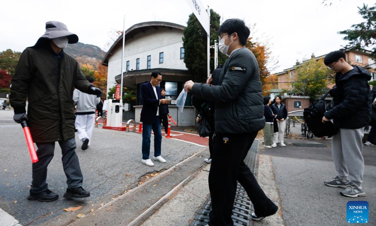 Examinees of the College Scholastic Ability Test (CSAT) enter the Gyeongbok High School in Seoul, South Korea, Nov. 14, 2024. South Korean students on Thursday took an annual college entrance exam, seen highly important in an education-obsessed society. A total of 522,670 high school students and graduates registered for the single-day five-session test this year, up 18,082 compared to the previous year.  (Photo: Xinhua)