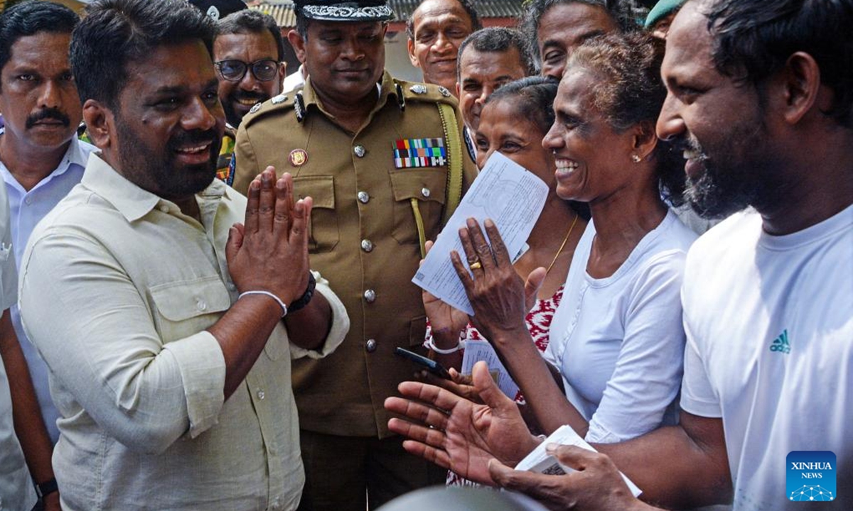 Sri Lankan President Anura Kumara Dissanayake (L, front) leaves a polling station after casting his vote in Colombo, Sri Lanka on Nov. 14, 2024. Voting in the Sri Lankan parliamentary election began on Thursday morning at 7:00 a.m. local time after the opening of polling stations across the South Asian country.   (Photo: Xinhua)