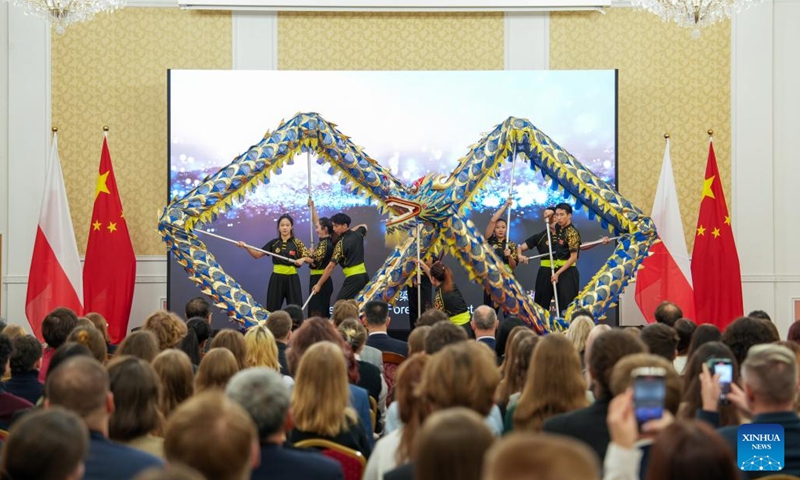 Members of the Dragon and Lion Art Troupe from China's Hubei University perform a dragon dance during an open day event as part of celebrations marking the 75th anniversary of diplomatic relations between China and Poland, at the Chinese Embassy in Poland in Warsaw, Poland, on Nov. 14, 2024. (Photo: Xinhua)