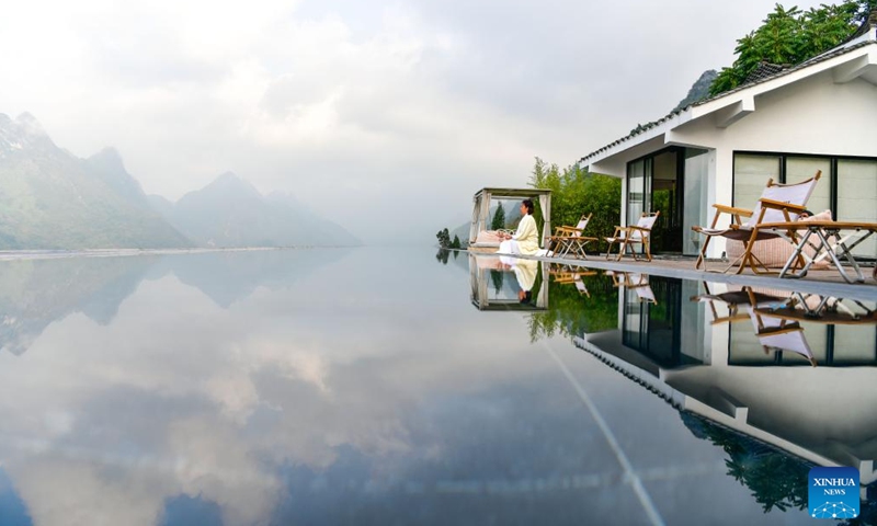 A tourist practices yoga at a homestay at Huangguoshu Scenic Area in Anshun City, southwest China's Guizhou Province, Nov. 14, 2024. (Photo: Xinhua)