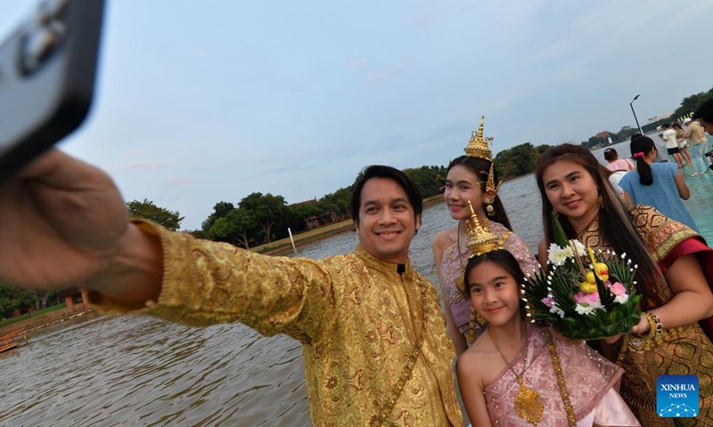 People take selfies with a water lantern during the Loy Krathong Festival by the Chao Phraya River in Ayutthaya, Thailand, Nov. 15, 2024. (Photo: Xinhua)