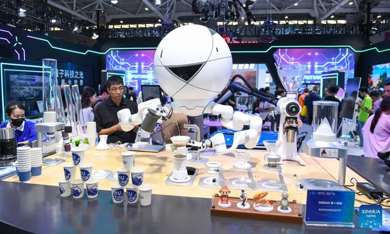 A robot makes coffee at a booth at the 26th China High-Tech Fair (CHTF) in Shenzhen, south China's Guangdong Province, Nov. 14, 2024. A variety of robots and products of related industries are exhibited at the ongoing 26th CHTF, attracting lots of attention.(Photo: Xinhua)