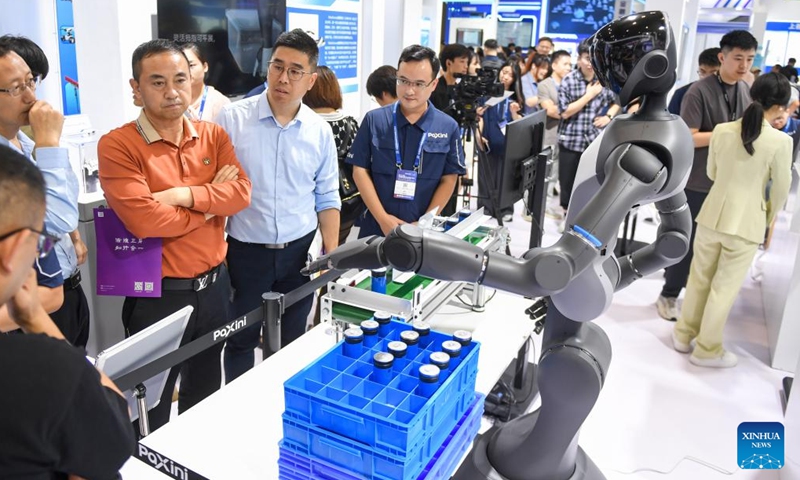 Visitors learn about a humanoid robot at a booth at the 26th China High-Tech Fair (CHTF) in Shenzhen, south China's Guangdong Province, Nov. 14, 2024. A variety of robots and products of related industries are exhibited at the ongoing 26th CHTF, attracting lots of attention. (Photo: Xinhua)