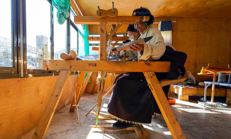 Doltru (front) weaves textiles at her workshop in Dege County of Garze Tibetan Autonomous Prefecture, southwest China's Sichuan Province, Nov. 3, 2024.(Xinhua/Shen Bohan)