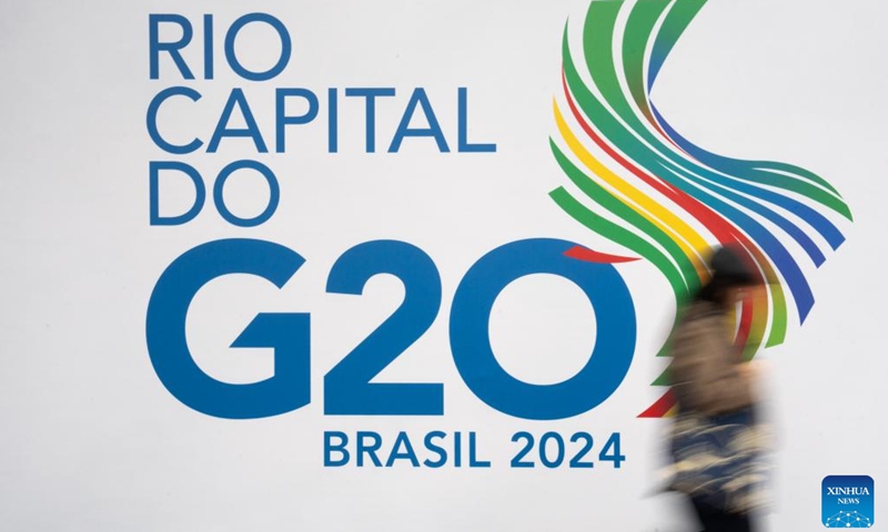 A woman walks past a G20 logo near the main venue of the 19th G20 summit in Rio de Janeiro, Brazil, Nov. 16, 2024. The 19th G20 summit is scheduled from Nov. 18 to 19 in Rio de Janeiro. (Xinhua/Wang Tiancong)