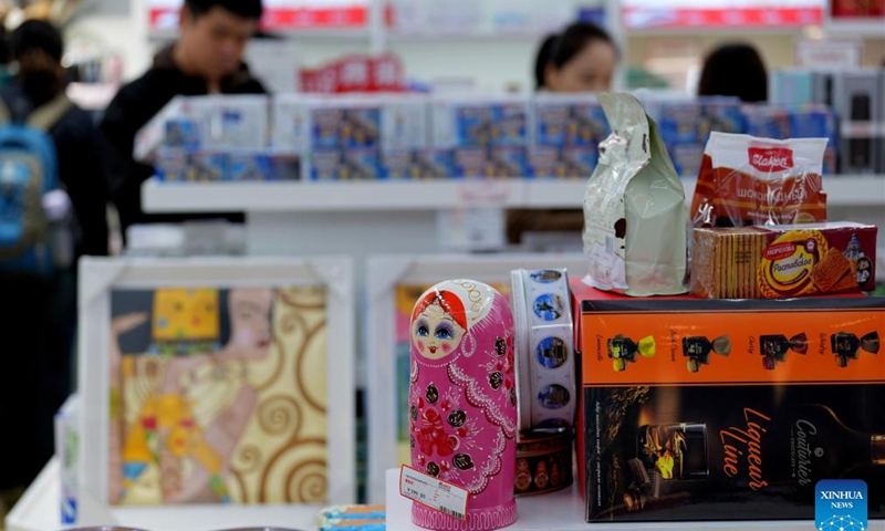 People buy products at a shop selling bonded commodities at Hankou Railway Station in Wuhan, central China's Hubei province, Nov. 17, 2024. A special outlet for bonded goods transported by China-Europe freight trains at Hankou Railway Station provides costumers with products in rich categories from countries in the freight train services network. (Xinhua/Xing Guangli)