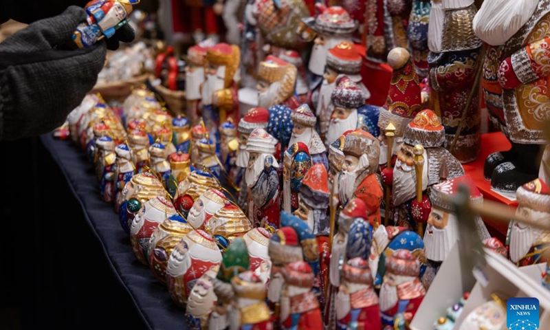 People choose Christmas products at a Christmas market in downtown Budapest, Hungary on Nov. 15, 2024. (Photo by Attila Volgyi/Xinhua)