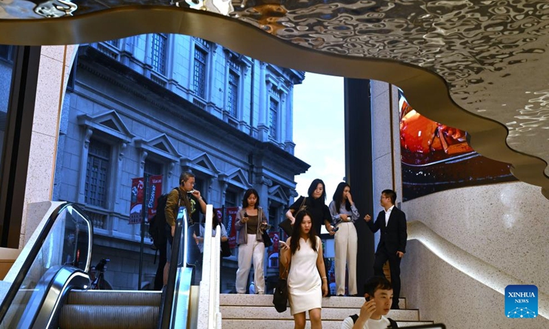 People walk into the M8 in Macao, south China, Nov. 15, 2024. Located at the heart of the historic center of Macao and just 50 meters from Senado Square, the M8, a key commercial urban redevelopment project in Macao, is expected to be open to the public at the end of November. (Xinhua/Jin Liangkuai)