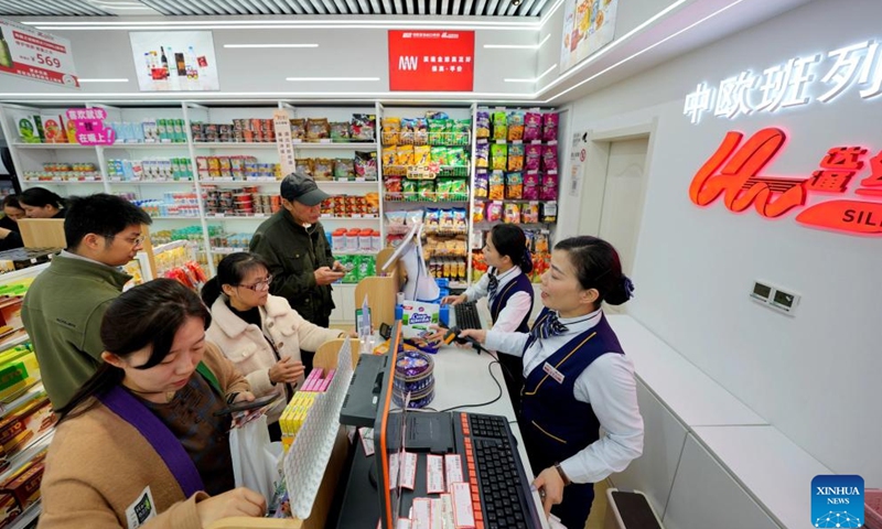 People buy products at a shop selling bonded commodities at Hankou Railway Station in Wuhan, central China's Hubei province, Nov. 17, 2024. A special outlet for bonded goods transported by China-Europe freight trains at Hankou Railway Station provides costumers with products in rich categories from countries in the freight train services network. (Xinhua/Xing Guangli)