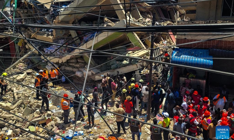 Rescuers search for survivors from a collapsed building in the Kariakoo suburb of Dar es Salaam, Tanzania, on Nov. 16, 2024. Tanzanian Prime Minister Kassim Majaliwa announced on Saturday that one person was killed and 28 others were injured when a four-story building collapsed in the Kariakoo suburb of Dar es Salaam, the country's port city. (Str/Xinhua)