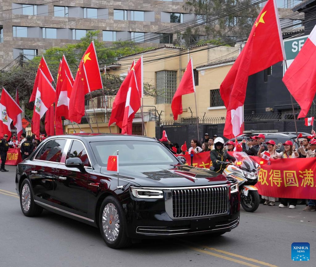 People wave the national flags of China and Peru by the road as Chinese President Xi Jinping leaves for the airport in Lima, Peru, Nov. 17, 2024. Xi left Lima on Sunday after attending the 31st APEC Economic Leaders' Meeting and paying a state visit to the Republic of Peru. (Xinhua/Bi Xiaoyang)