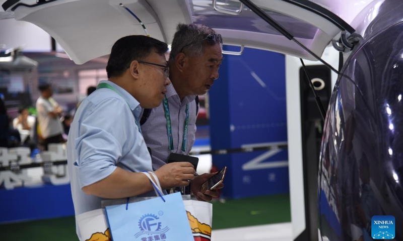 Visitors look at an electric vertical take-off and landing (eVTOL) aircraft during the 15th China International Aviation and Aerospace Exhibition, also known as Airshow China, in Zhuhai, south China's Guangdong Province, Nov. 13, 2024. (Xinhua/Hong Zehua)