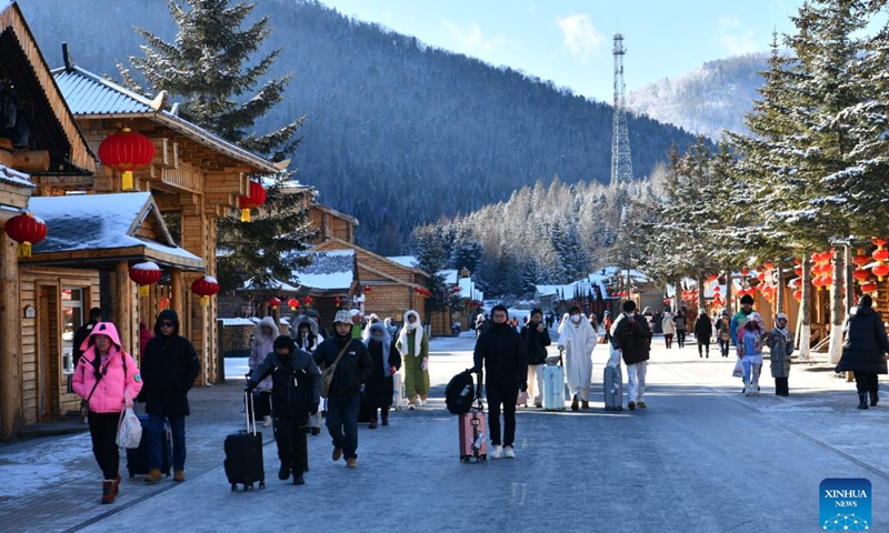 Tourists walk on a street of China's Snow Town scenic spot in Mudanjiang, northeast China's Heilongjiang Province, Nov. 17, 2024. The China's Snow Town scenic spot opened to the public on Sunday. (Photo by Wang Yanlong/Xinhua)