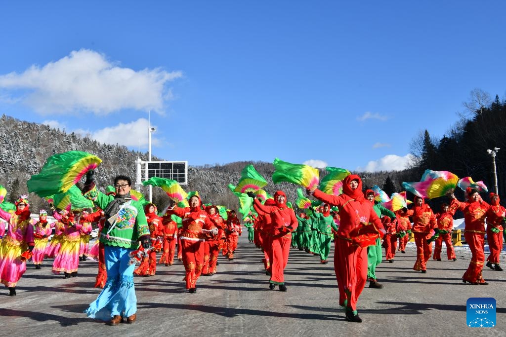 Yangge dancers perform to greet the tourists at the China's Snow Town scenic spot in Mudanjiang, northeast China's Heilongjiang Province, Nov. 17, 2024. The China's Snow Town scenic spot opened to the public on Sunday. (Photo by Wang Yanlong/Xinhua)