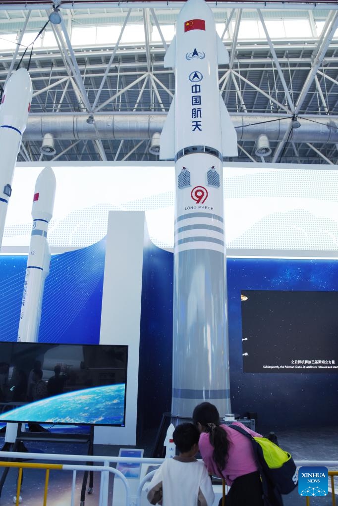 Visitors look at a model of the Long March-9 rocket during the 15th China International Aviation and Aerospace Exhibition, also known as Airshow China, in Zhuhai, south China's Guangdong Province, Nov. 15, 2024. (Xinhua/Hong Zehua)

