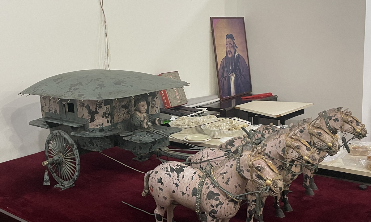 A miniature model of a bronze carriage from the Terracotta Army and a portrait of Confucius are seen at the Confucius Institute of the University of Brasilia Photo: Wang Qi/GT