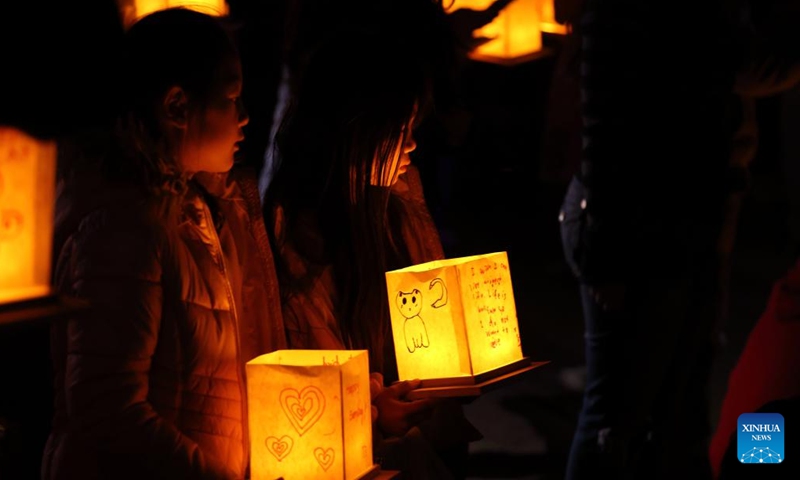 Children prepare to set afloat water lanterns during a water lantern festival in South El Monte, Los Angeles, California, the United States, on Nov. 17, 2024. (Photo: Xinhua)