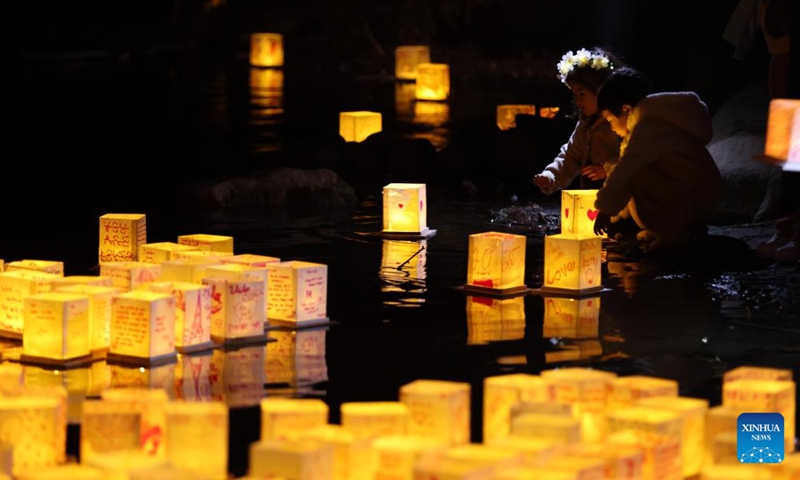 Children set afloat water lanterns during a water lantern festival in South El Monte, Los Angeles, California, the United States, on Nov. 17, 2024. (Photo: Xinhua)