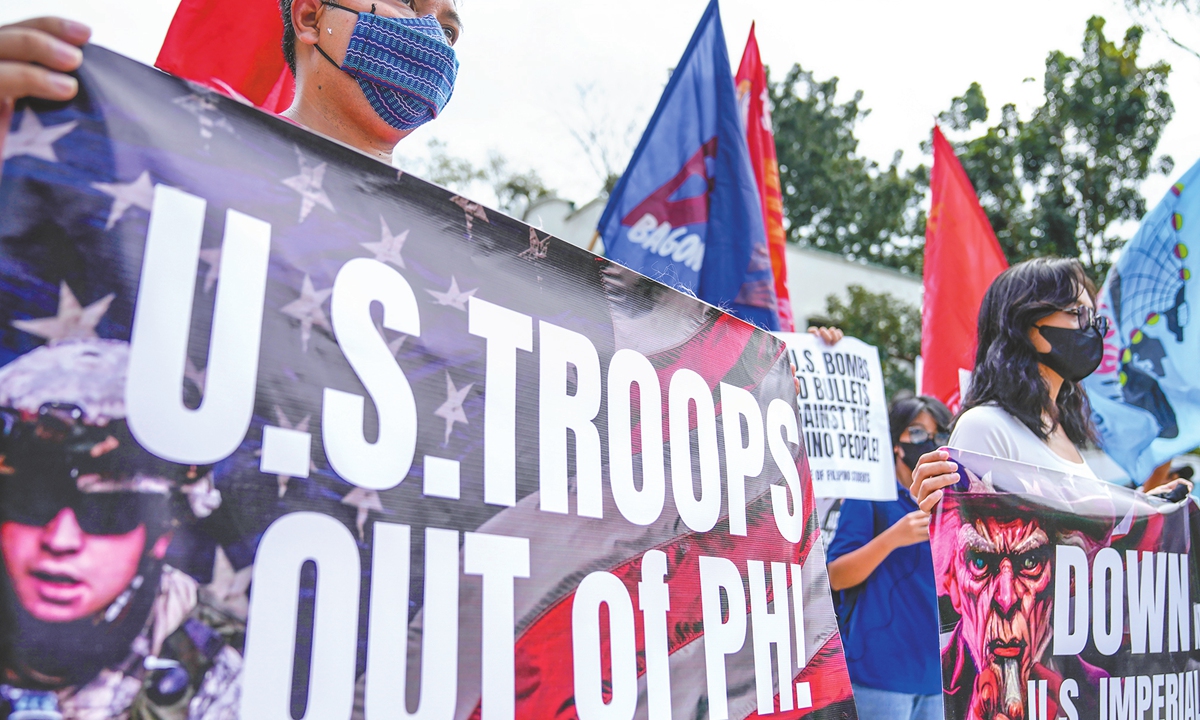 Demonstrators hold banners during a protest against the visit of US Defense Secretary Lloyd Austin in Manila, the Philippines, on February 2, 2023. Photo: VCG