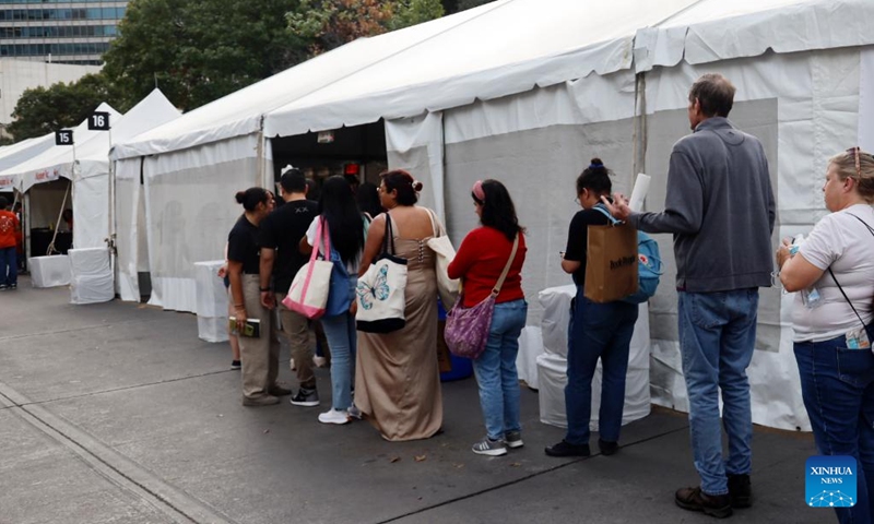 People line up to get the authors' signature during the Texas Book Festival in Austin, Texas, the United States, Nov. 16, 2024. (Photo: Xinhua)