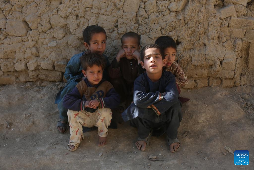 Children pose for photos at a displaced camp in Kabul, Afghanistan, Nov. 19, 2024. (Photo: Xinhua)