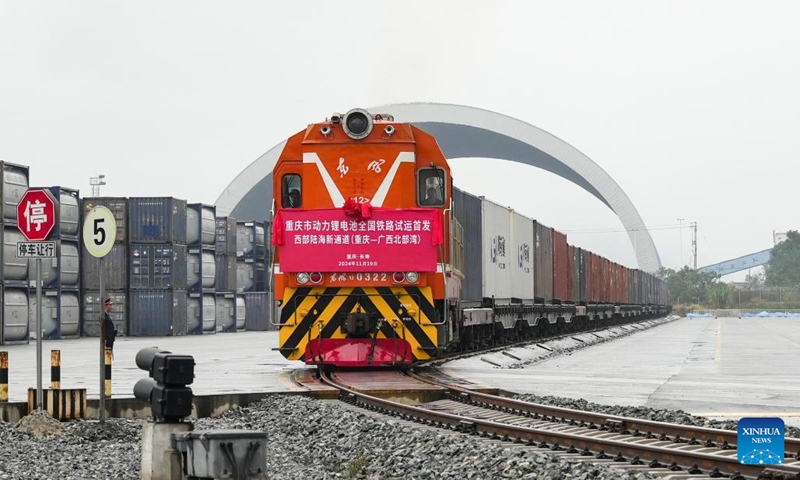 A train loaded with lithium batteries for traction purposes departs from a train station in southwest China's Chongqing, Nov. 19, 2024. Three trains loaded with lithium batteries for traction purposes departed separately from Chongqing, Guiyang and Yibin on Tuesday, marking the first large scale test run for rail transportation of such batteries in China. A new type of container enhanced with multiple safety measures including smoke sensing and pressure releasing has been deployed to effectively reduce potential risks during transportation. (Xinhua)