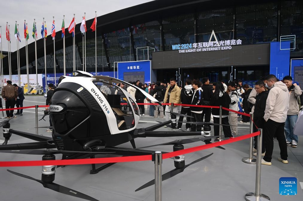 Visitors view an electric passenger-carrying autonomous aerial vehicle at the Light of Internet Expo in Wuzhen, east China's Zhejiang Province, Nov. 19, 2024. The Light of Internet Expo kicked off on Tuesday during the 2024 World Internet Conference (WIC) Wuzhen Summit in the water-town of Wuzhen, showcasing the latest technological achievements, especially those made in the artificial intelligence (AI) area. (Photo: Xinhua)