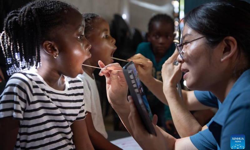 Members of the Chinese medical team conduct oral examinations for children at the Frans Nambinga Arts and Training Center in Windhoek, Namibia, Nov. 20, 2024.(Xinhua/Chen Cheng)